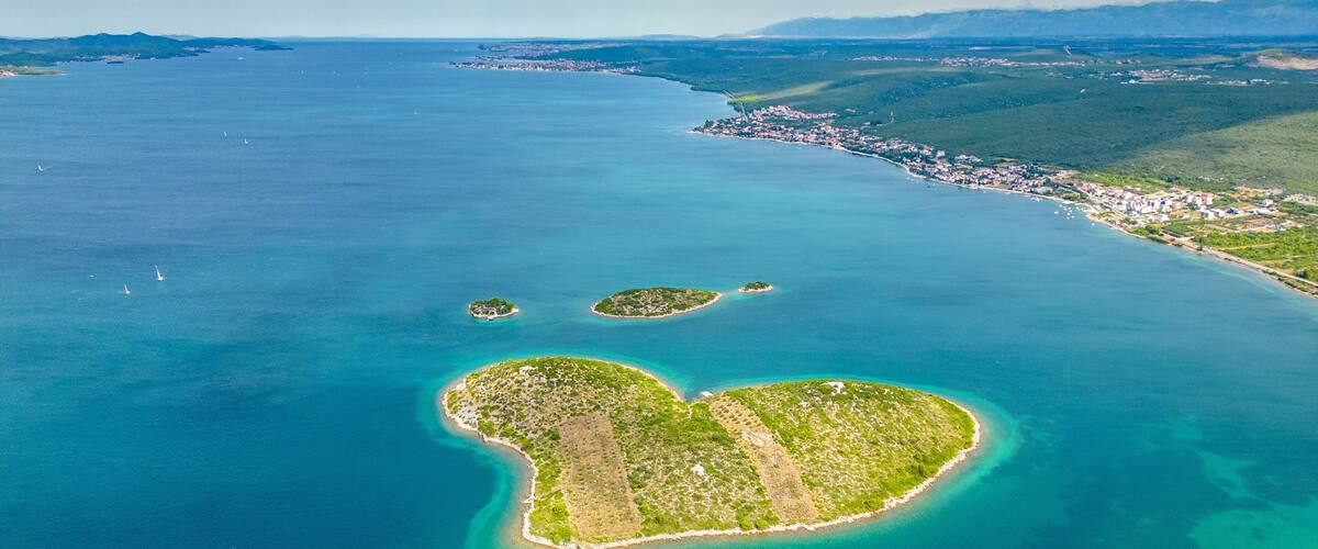 Aerial view of Galešnjak, the famous heart-shaped island located near Sveti Filip i Jakov in the Adriatic Sea, Croatia. Known as the “Island of Love,” it is one of the world’s most romantic natural