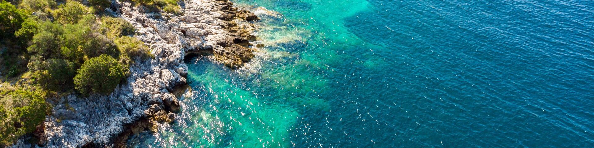Spectacular aerial sea landscape of rocky coast and crystal clear water.