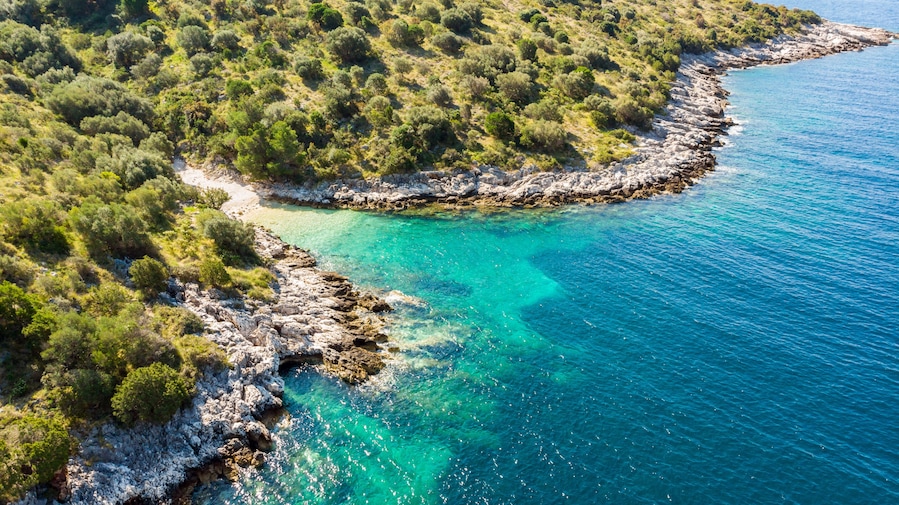 Spectacular aerial sea landscape of rocky coast and crystal clear water.