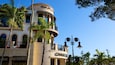 A building with a 'Chase' sign, palm trees, and a clear blue sky.