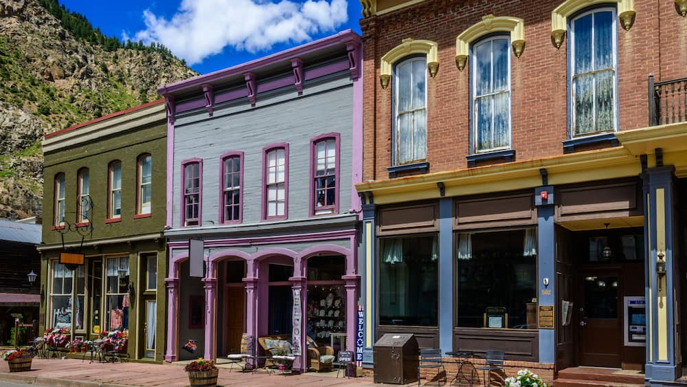 Old brick buildings, once a mining boom town, now a charming tourist destination. The buildings showcase early American architectural styles.