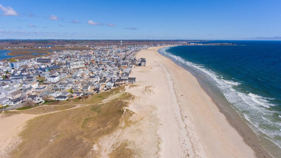 A coastal town with a beach, ocean, and residential area.
