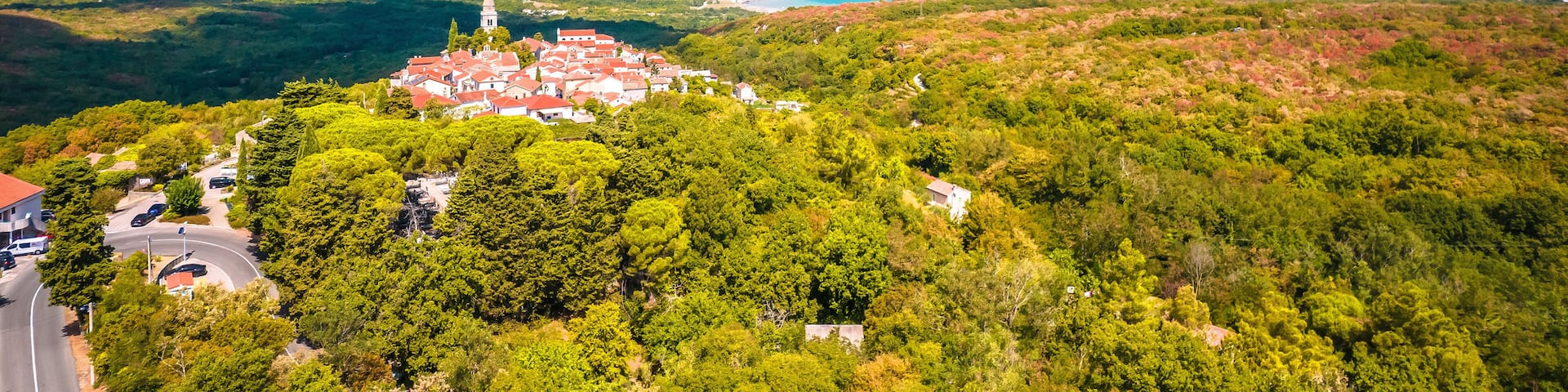 Historic town of Dobrinj and turquoise Soline bay aerial panoramic view
