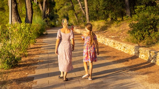 Mother and daughter are walking on the path, Mali Losinj, Croatia