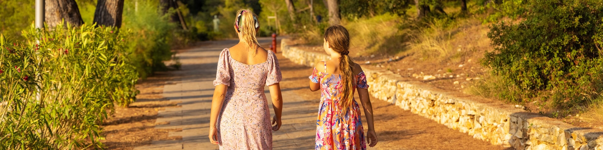 Mother and daughter are walking on the path, Mali Losinj, Croatia