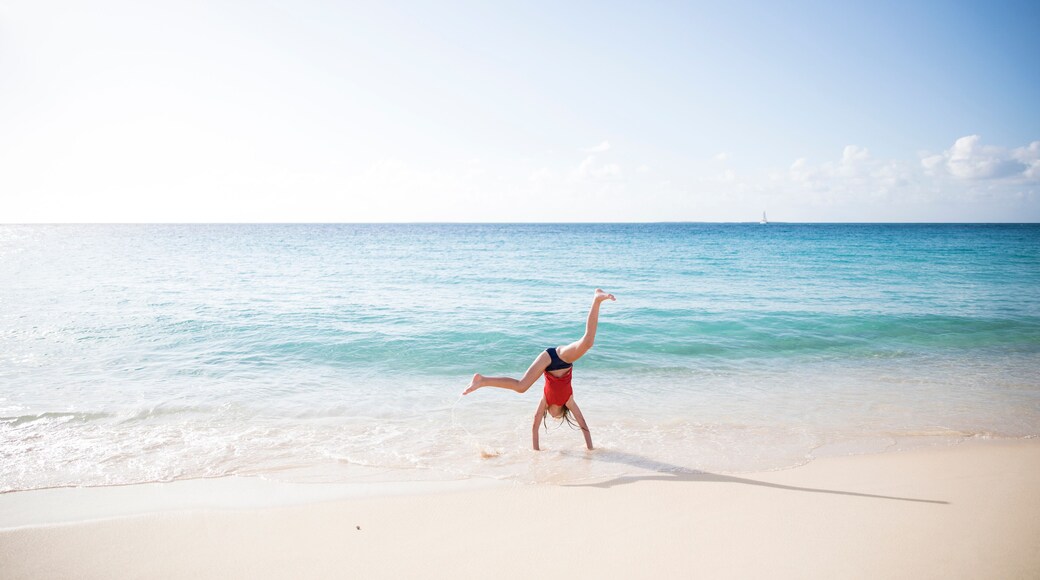 Young Girl Does Cartwheel on Edge of Turquoise Caribbean Ocean