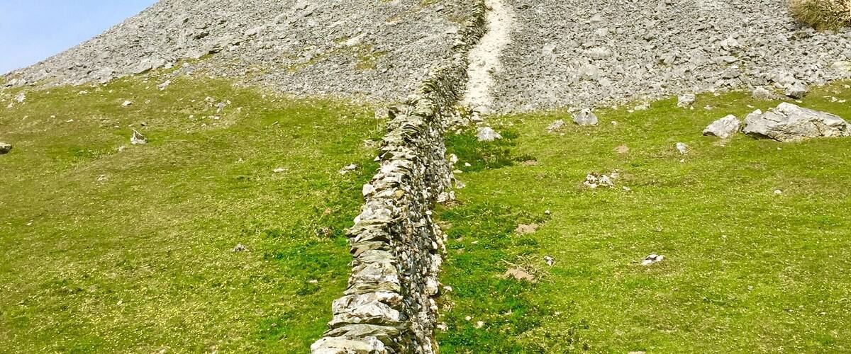 Drystone wall heading up onto Robin Proctor’s Scar. The Scar is popular with rock climbers.