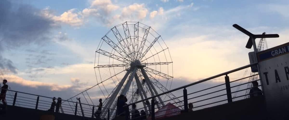 A Ferris wheel against a sunset sky.