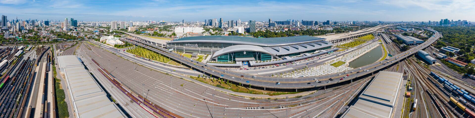Panoramic view of Bangkok skyline with new Bang Sue Grand Station in Bangkok, Thailand. Aerial view of Passenger and freight trains. Expressway top view