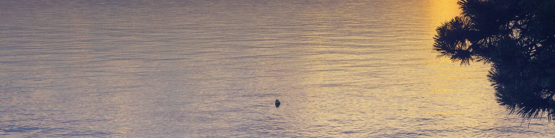 Peaceful scene at the beach of Adriatic sea with beautiful clouds at sunset time. Summer vacation, travel and tourism concepts