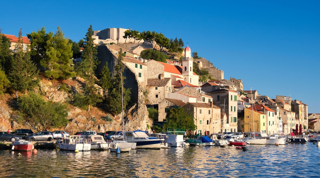 Dramalj, village in Crikvenica, Croatia. Summer holiday destination, view from across the sea. Shore And Boats On Adriatic Coastline with reflection.