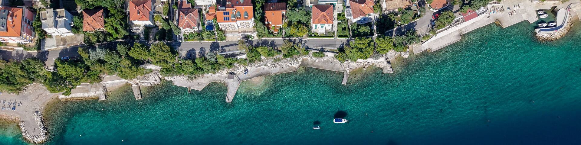 Aerial drone view of Crikvenica and Dramalj with turquoise Adriatic Sea, green-blue waters, beaches, and the island of Krk in the distance. Taken on 27.09.2025 in Dramalj, Croatia.