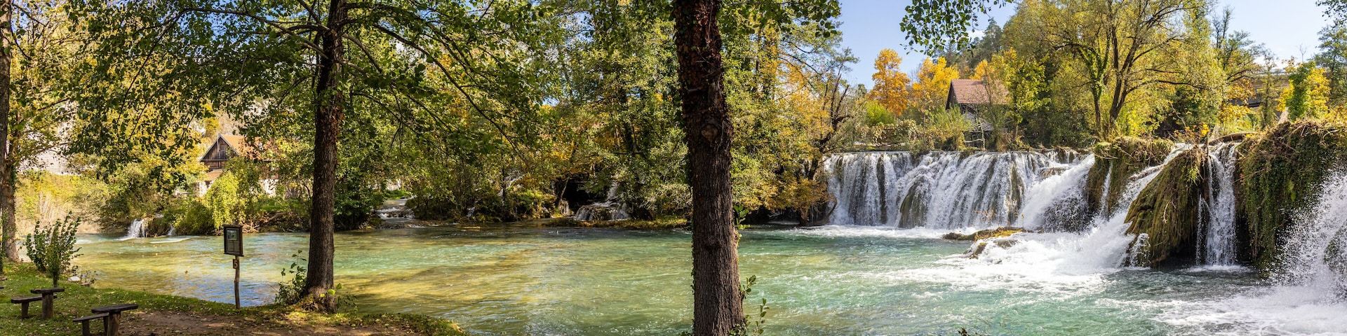 Panoramic photograph of the Rastoke Waterfalls, where the Slunjčica River meets the Korana River, creating a dreamlike landscape. Rastoke, Croatia