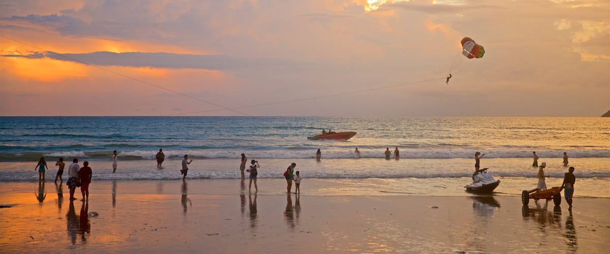 Patong showing a sunset, water sports and a sandy beach
