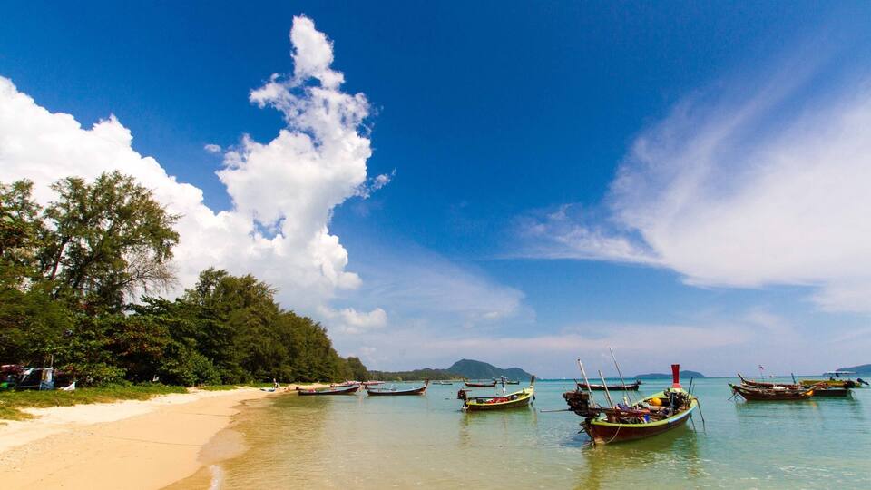 A beach with boats and clear blue sky.