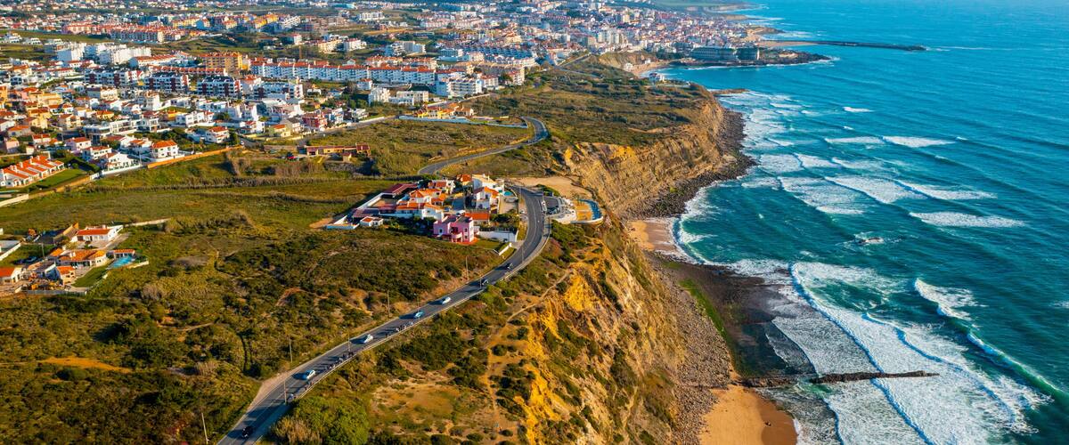 Drone aerial view over beaches, coastlines in Ericeira, Portugal, on summer sunny day. Aerial view to the Beautiful European touristic town. Beautiful cityscape with skyline, ocean rocky shore. Travel