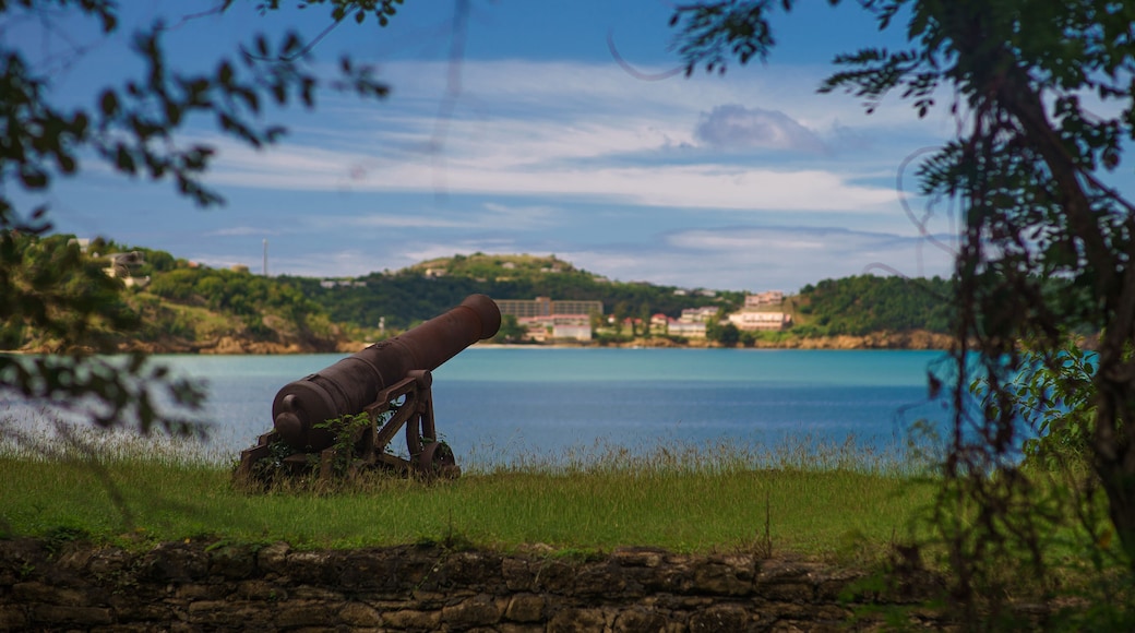 Old cannon in the fort is looking at sea with amazing clouds and island on background