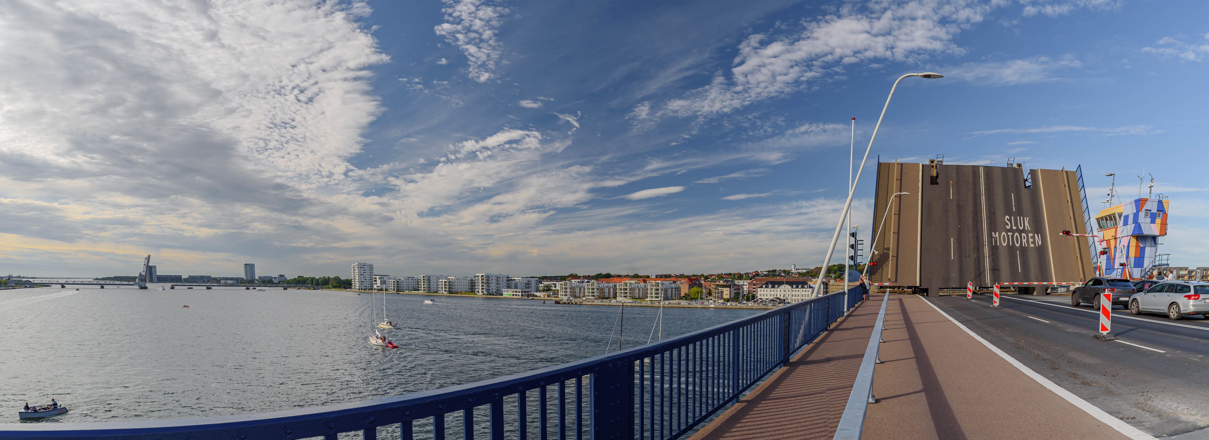 The Limfjord bridge opens for ship traffic from driver perspective.  Limfjordsbroen bridge which connects Nørresundby and Aalborg over Limfjord, a shallow sound.  Bascule bridge across the Langerak.