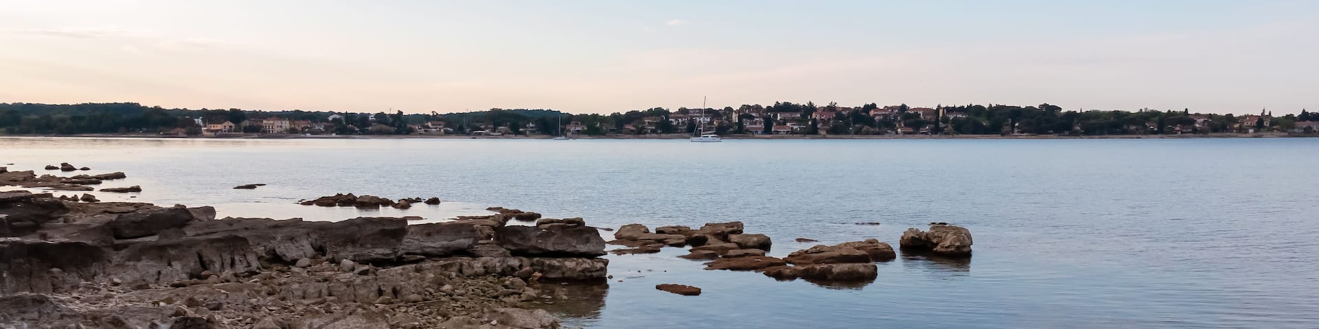 Scenic morning view at sunrise of picturesque coastal town Dajla seen from Karigador, Istria peninsula, Croatia. Village is nestled along the waterfront of Adriatic Mediterranean sea. Summer vacation