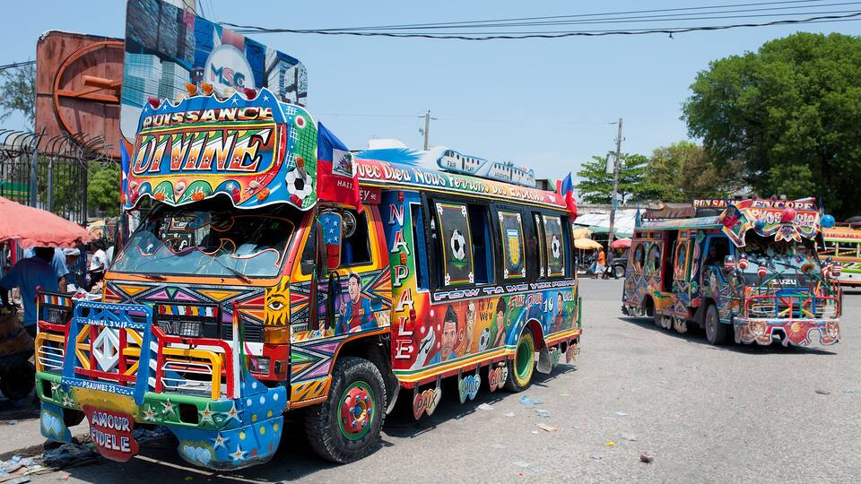 A colorful bus with vibrant decorations and text.