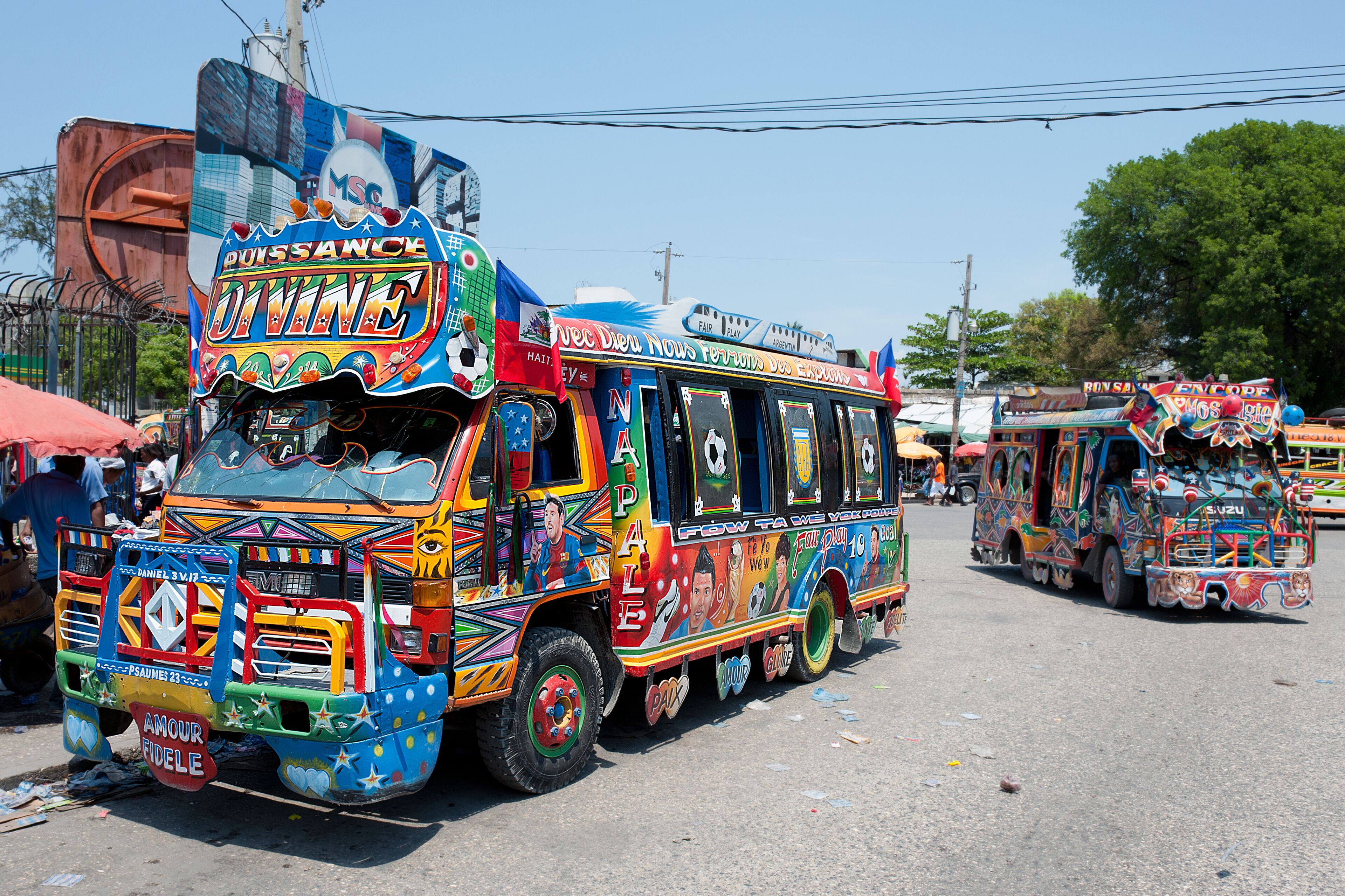 A colorful bus with vibrant decorations and text.