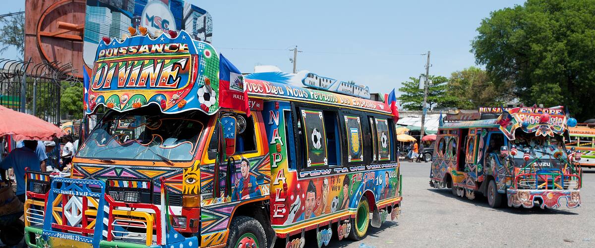 A colorful bus with vibrant decorations and text.