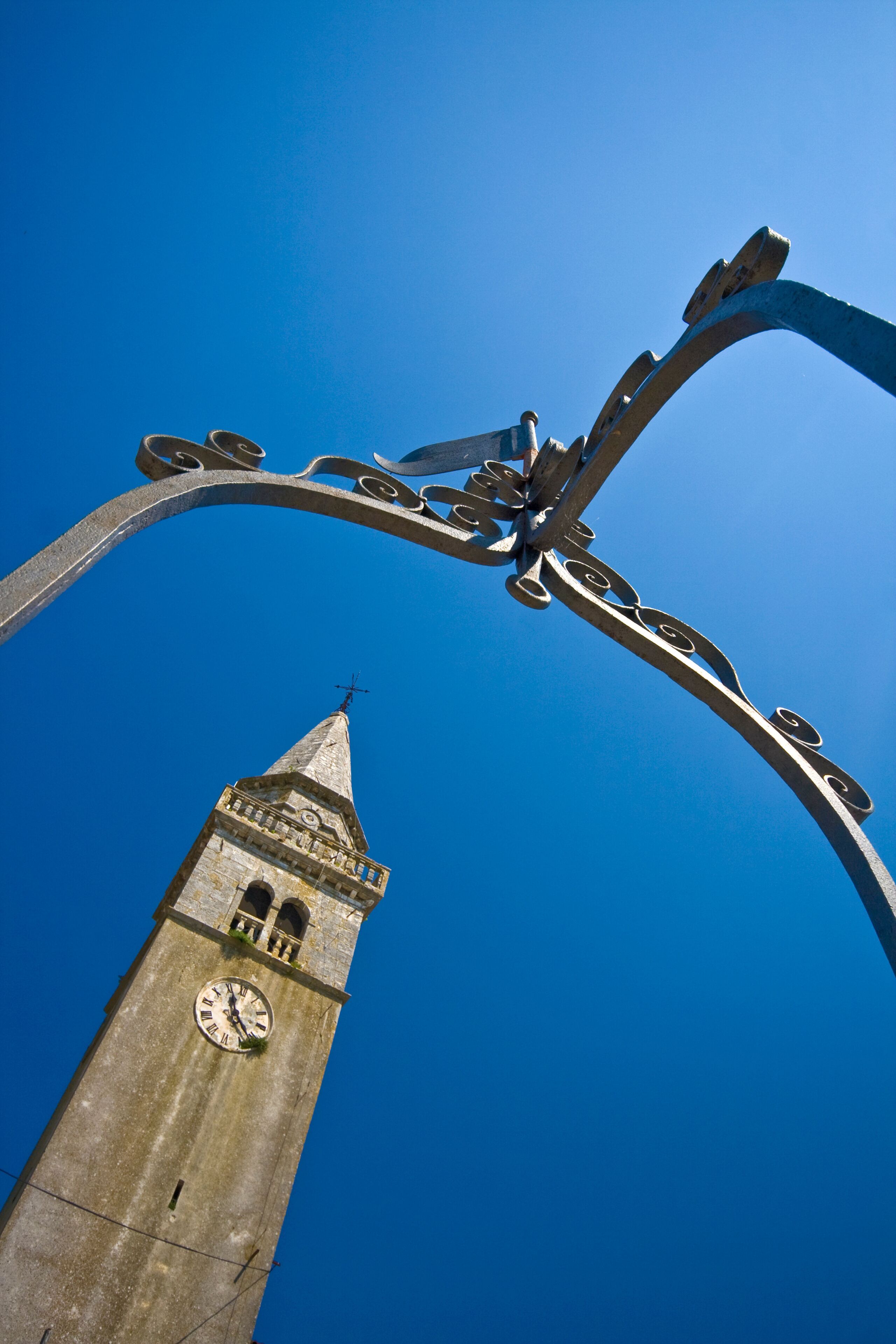 Church and the clock tower from the well in Zminj