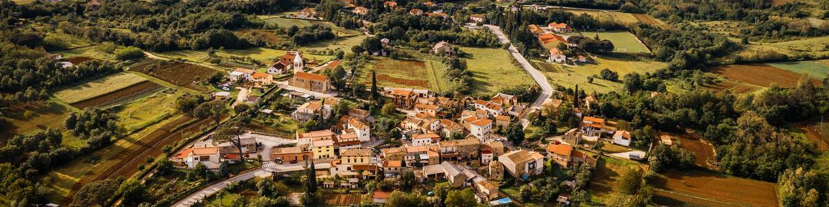 Aerial view of a village with mountains in the background on cloudy day in Karojba, Croatia