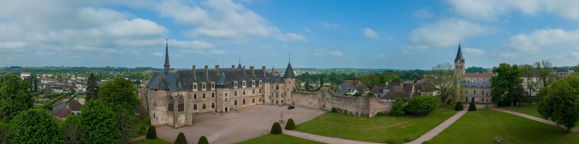 Aerial panoramic view of Lapalisse castle in the Allier department of the Auvergne-Rhône-Alpes in France with Renaissance wing from rose colored brick, Gothic chapel