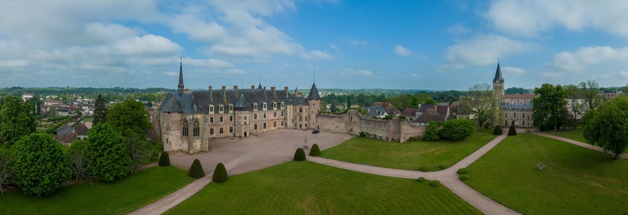 Aerial panoramic view of Lapalisse castle in the Allier department of the Auvergne-Rhône-Alpes in France with Renaissance wing from rose colored brick, Gothic chapel