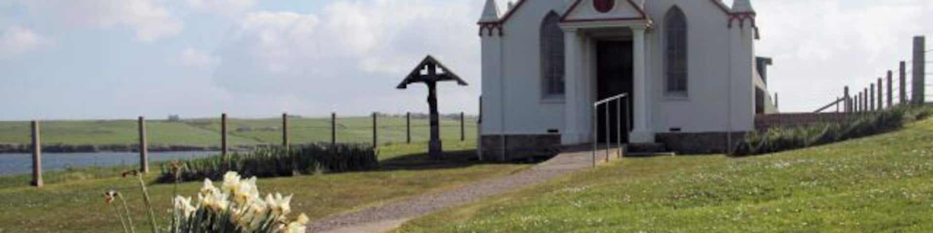 Italian Chapel on Lamb Holm A late bunch of daffodils decorates the entrance path to the chapel.