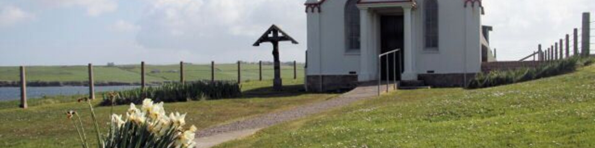 Italian Chapel on Lamb Holm A late bunch of daffodils decorates the entrance path to the chapel.