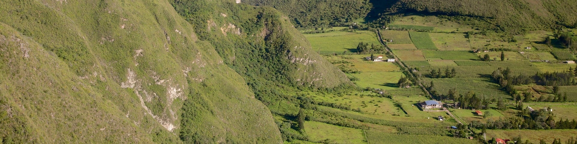Quito featuring farmland, mountains and landscape views