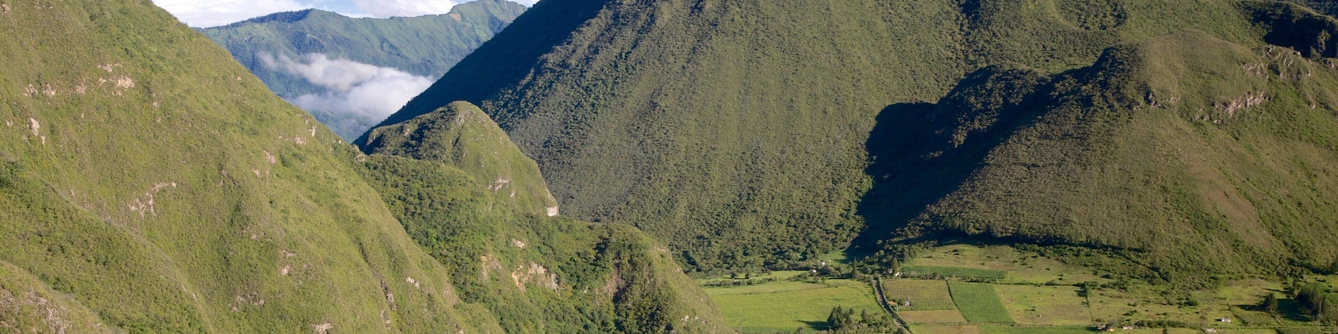 Quito featuring farmland, mountains and landscape views