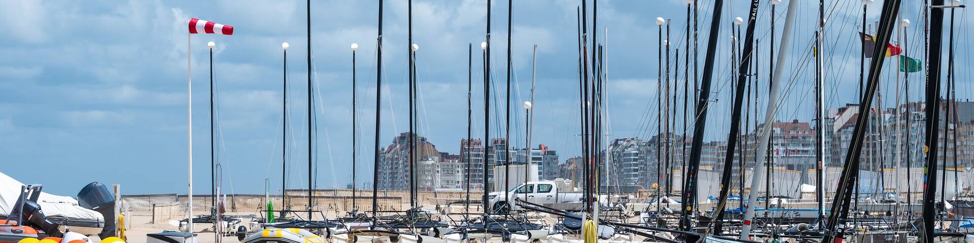 Sporty sailing vessels at the sand beach of Knokke Heist, West Flanders, Belgium