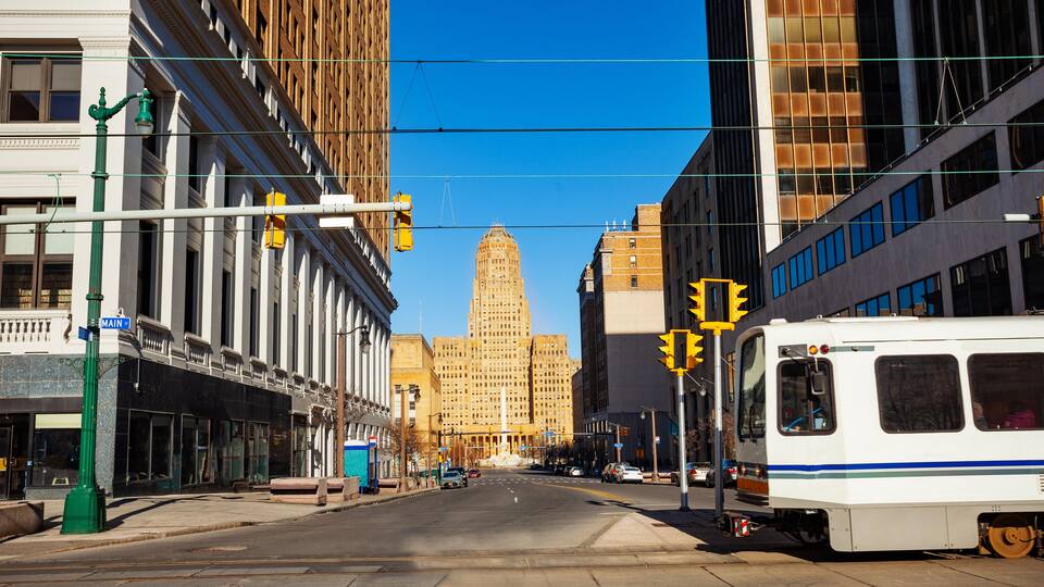 McKinley monument with city hall on Niagara Square and streetcar tram on main street on foreground