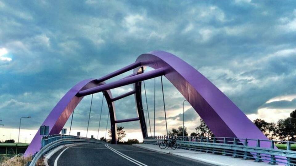 A purple bridge with a curved arch design.