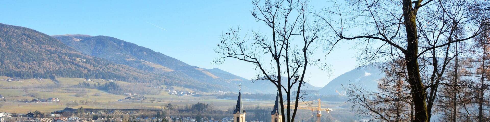 Amazing winter view of Brunico with Santa Maria Assunta church in the middle of the picture, Bruneck, Italy