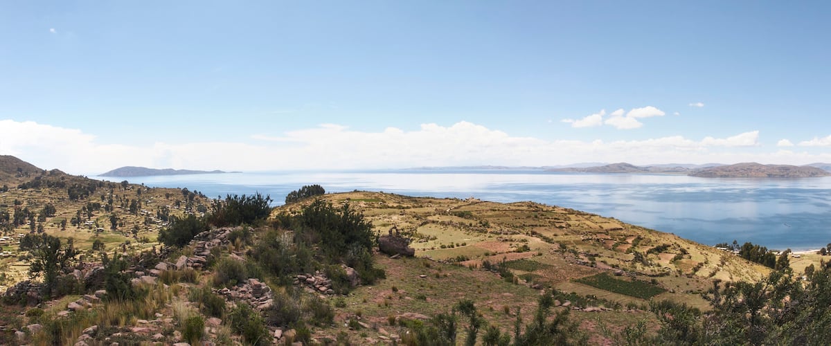 A mountainous landscape with a large body of water in the background.