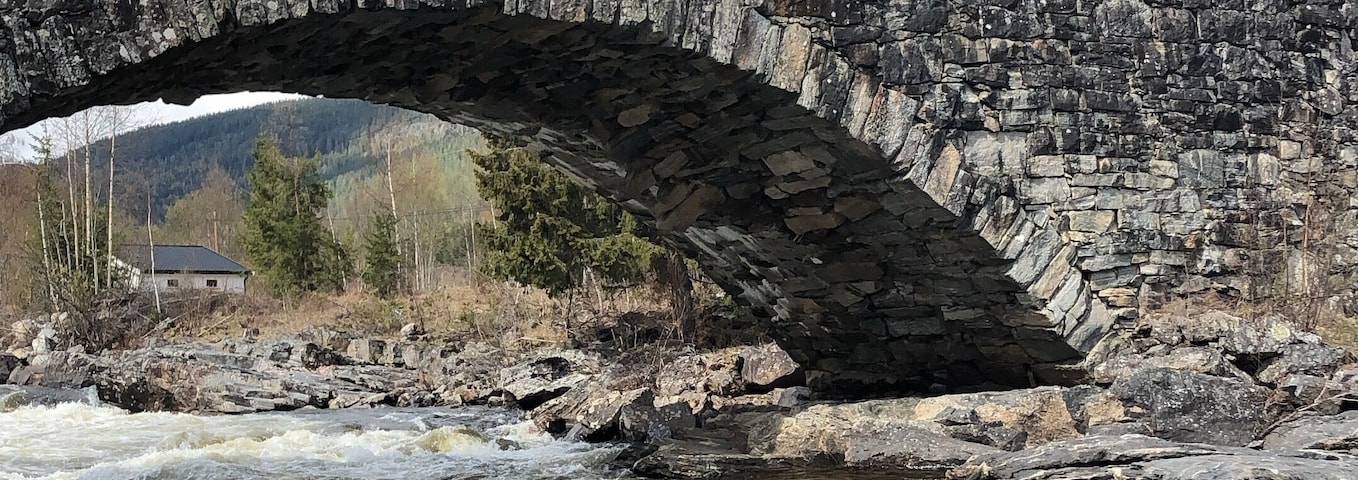 Lunde bridge and the river Etna.
Wikipedia note: âIt is one of the best preserved stone bridges in the country and it is now a national monument. It is also Northern Europe's largest dry stone-arch bridge. The bridge was built in 1829 on the Old King's Road to Bergen. A portion of the kingâs road was refurbished and turned into a footpath in 1992 and is now a natural and cultural walking path.â