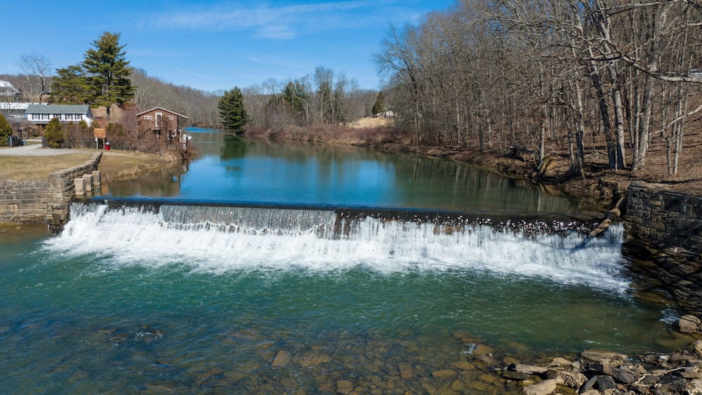 Aerial view of the Bruceton Mills waterfall gracefully flowing through a small town in West Virginia