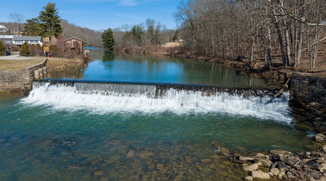 Aerial view of the Bruceton Mills waterfall gracefully flowing through a small town in West Virginia