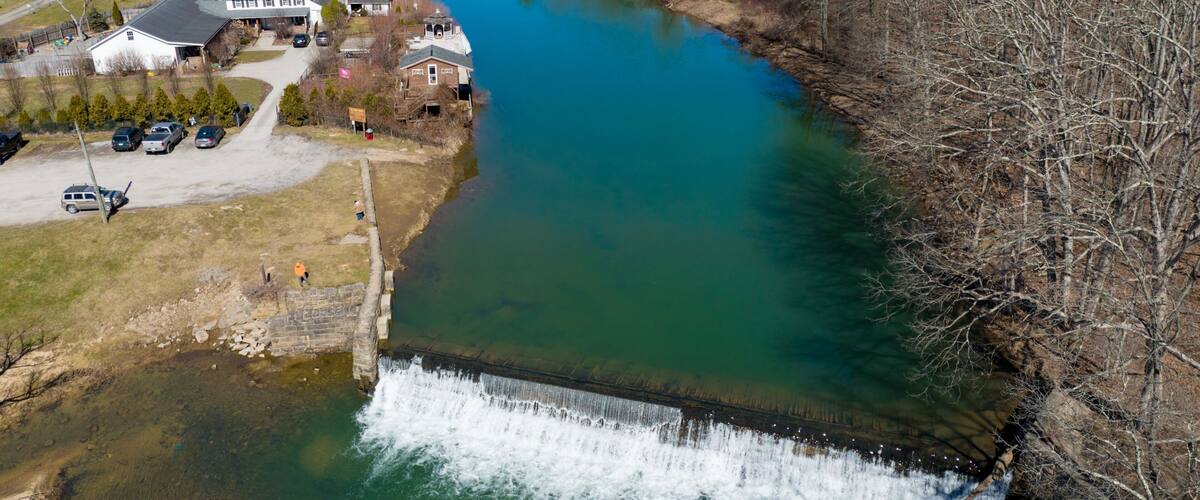Aerial view of the Bruceton Mills waterfall gracefully flowing through a small town in West Virginia