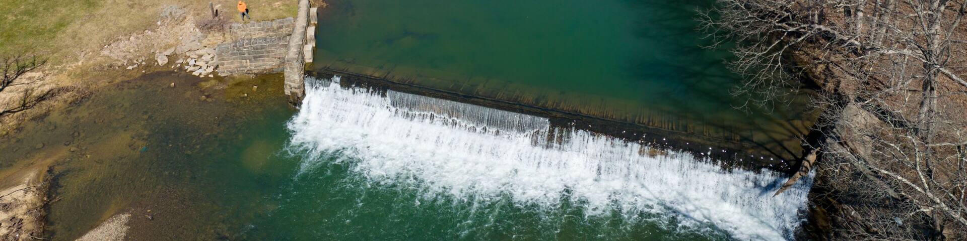 Aerial view of the Bruceton Mills waterfall gracefully flowing through a small town in West Virginia