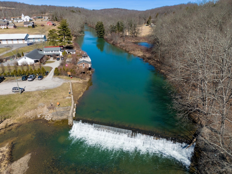 Aerial view of the Bruceton Mills waterfall gracefully flowing through a small town in West Virginia