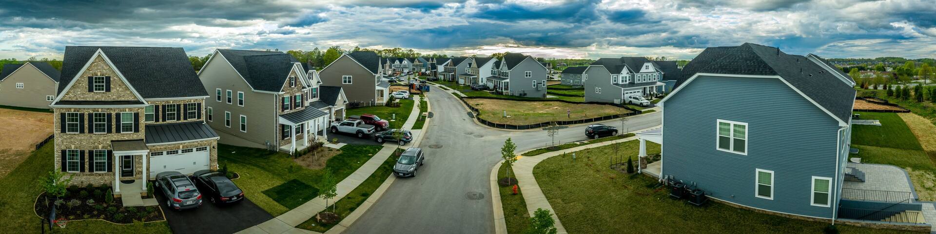 Aerial panorama of new construction luxury residential neighborhood street with American single family homes in Maryland USA real estate