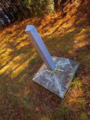 1842 Canada/USA border marker in the forest, stone and metal