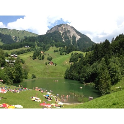 Seewaldsee is a well hidden lake, just below the Seewald mountain. Emerald water, not too cold, gorgeous views.
It is a 30 min walk from the road between Fontanella and Damühls. You can't get there by car, but these days a small train brings those who are not able to walk and still want to enjoy the lake.
http://www.seewaldsee.at/ can't #camp there, sorry.