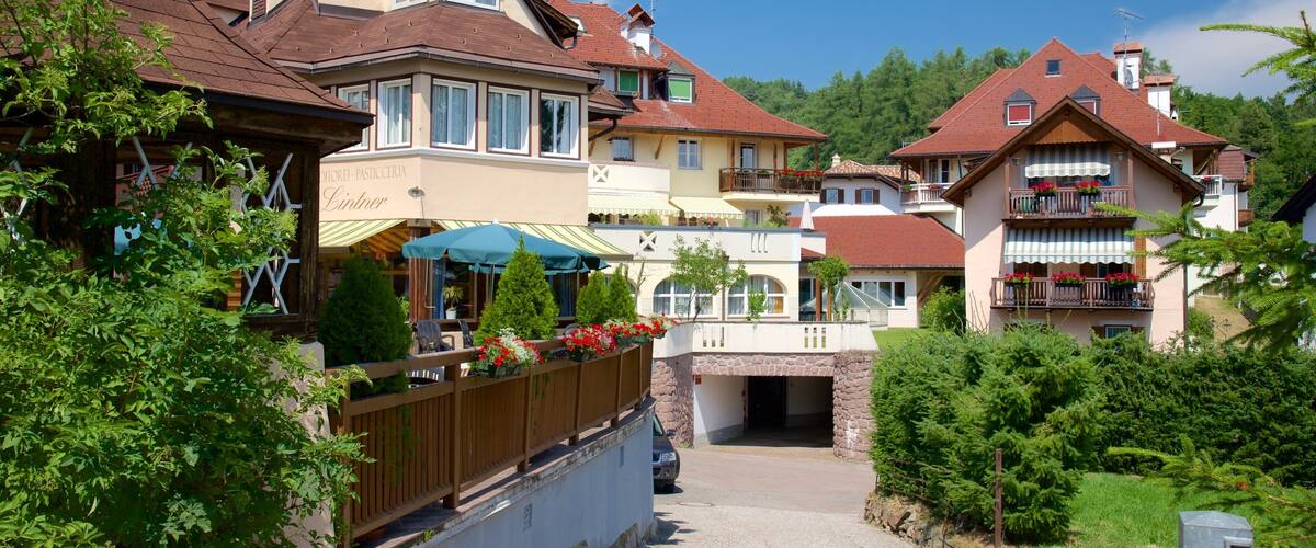 A quaint village with traditional houses, a bakery, and a stone bridge.