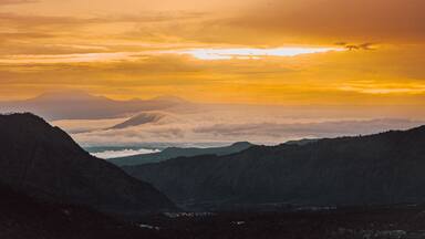 Bromo Tengger Semeru National Park in Indonesia, with calderas, mountains, and a colorful sky
